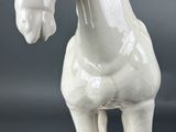 a white horse that is standing on a table