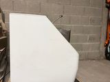 a piece of white marble on a pallet in a warehouse