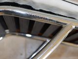 a close up of a metal chair with snow on it