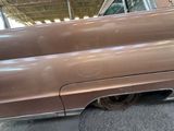 a brown car that is parked in a garage
