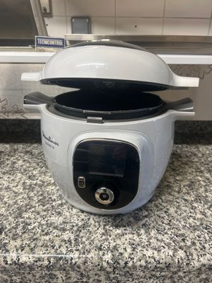 a white rice cooker sitting on a counter top