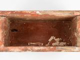 a small wooden box with a broken window in it