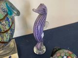 a lot of glass figurines on a blue table