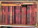 many old books in a wooden box on a shelf