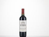 a bottle of red wine sitting on top of a table