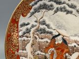 a decorative plate with a painting of a woman and a dog