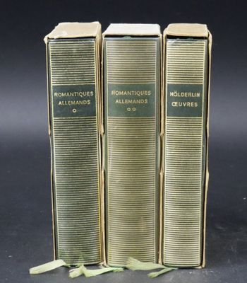 three books are stacked on top of each other on a table