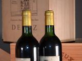 two bottles of wine sitting next to each other on a table