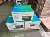 three boxes of printer sitting on top of a pallet in a warehouse