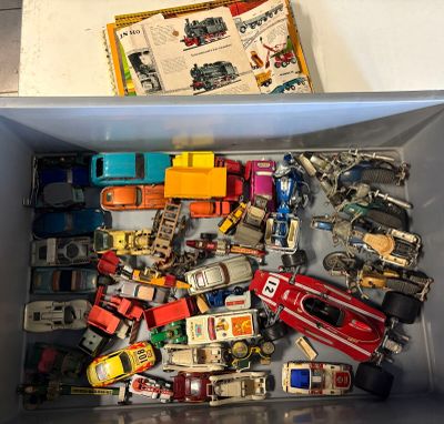 a lot of toy cars in a box on the table