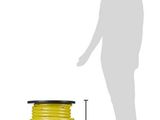 a spool of yellow wire with a man standing next to it