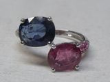 pair of blue and pink sapphire rings on a white surface