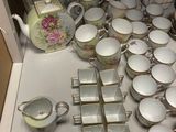 many different types of teapots and cups on the table