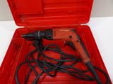 a red box with a drill and a cord in it