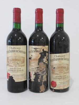 three bottles of wine sitting next to each other on a table