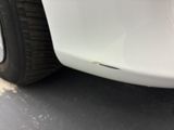 a close up of a car ' s front bumper and tire