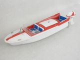 a toy boat that is sitting on a white surface