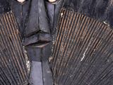 a metal sculpture of a man wearing a suit and tie