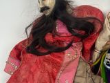 a doll of a man and a woman sitting on a chair