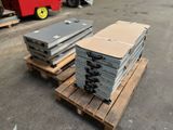 several pallets of metal are stacked on pallets in a parking lot