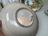 a person that is holding a bowl on a table