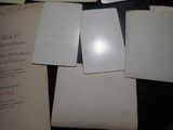 many papers that are on a table with a pen