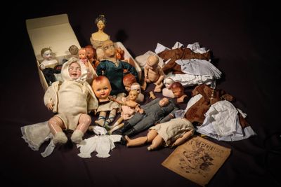 a lot of dolls that are sitting on a table