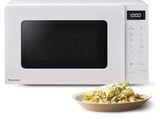 a plate of food on a plate next to a microwave