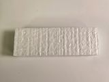 a piece of white paper on the table next to a piece of white paper