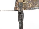a knife that is on top of a piece of metal