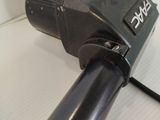 a black blow dryer sitting on top of a white table
