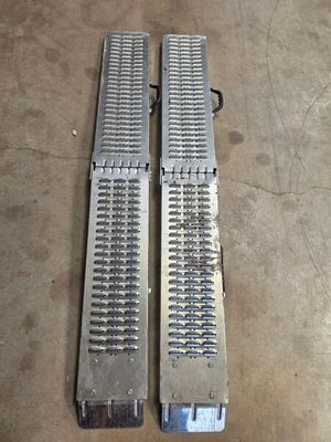 a pair of metal grates sitting on top of a cement floor