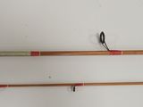 two fishing rods are hanging on the wall next to each other