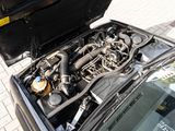 a car engine with its hood open on the street