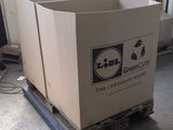 a cardboard box sitting on a pallet in a garage