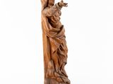 a wooden statue of a woman holding a child