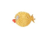 a close up of a gold fish brooch with a diamond in its mouth
