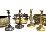 four different types of brass candlesticks and a bowl