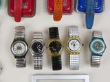 many different types of watches on a white surface