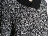 an image of a black and white sweater on a mannequin mannequin
