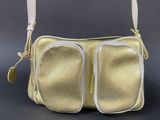 an image of a gold purse with two zippers on it