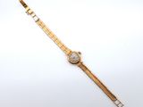 an image of a gold wrist watch with a white face on a white surface