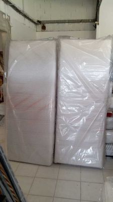 many rolls of plastic wrap on the floor in a warehouse