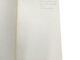 an open book with writing on it on a white surface