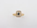 a yellow gold ring with a blue sapphire and diamonds