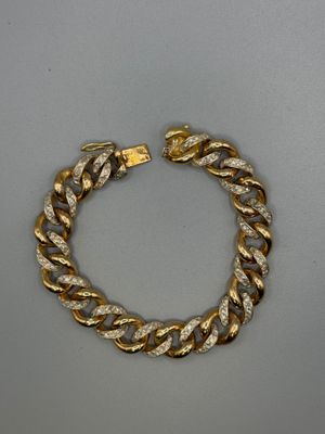 a gold chain bracelet with a diamond clasp