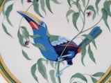 a plate with a bird painted on it on a table