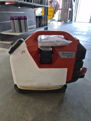 an image of a red and white lawn mower in a garage