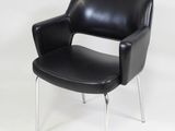 a black leather chair with chrome legs on a white background