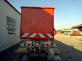 an image of a red and white truck parked in front of a building